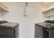 Laundry room featuring side by side black stainless washer and dryer and shelving at 3324 Peachtree Ne Rd # 2118, Atlanta, GA 30326