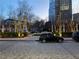 Outdoor parking area with well manicured shrubs and mature trees lit with strings of fairy lights at 3324 Peachtree Ne Rd # 2118, Atlanta, GA 30326