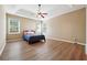 Spacious bedroom featuring tray ceiling, ceiling fan, and natural light from windows at 4985 Skyland Pkwy, Cumming, GA 30028