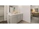 Bathroom featuring double sinks and a view to the bedroom adds convenience and charm at 9446 Cedar Grove Ct # 334, Jonesboro, GA 30238