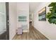 Bright entryway with wood flooring, leading into the house with welcome bench and decorative artwork displayed at 9450 Cedar Grove Ct # 332, Jonesboro, GA 30238