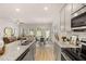 Open concept living area featuring a modern kitchen with stainless steel appliances connected to the dining and living spaces at 9450 Cedar Grove Ct # 332, Jonesboro, GA 30238