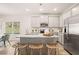 Well-lit kitchen with granite countertops, stainless steel appliances, large island with seating, and ample cabinet space at 9450 Cedar Grove Ct # 332, Jonesboro, GA 30238