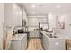 Spacious kitchen featuring sleek countertops, stainless steel appliances, stylish cabinetry, and hardwood floors at 9450 Cedar Grove Ct # 332, Jonesboro, GA 30238