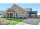 Brick and blue siding home showcasing an attached two-car garage and lush green lawn at 416 Sylvie Dr, Mcdonough, GA 30252