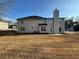 A sprawling backyard with lush grass and an expansive view of the home's rear elevation at 3689 Deer Springs Trl, Ellenwood, GA 30294