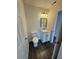 A bathroom with a vanity and a toilet featuring wood-look flooring at 3689 Deer Springs Trl, Ellenwood, GA 30294