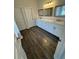 A bathroom with dual sinks and a bathtub featuring wood-look flooring at 3689 Deer Springs Trl, Ellenwood, GA 30294