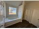 A bathroom with a bathtub and shower featuring wood-look flooring at 3689 Deer Springs Trl, Ellenwood, GA 30294
