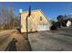 Home exterior featuring a side entry garage, basketball hoop and ample parking space at 3689 Deer Springs Trl, Ellenwood, GA 30294
