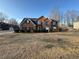 Charming two-story brick home with a manicured lawn and mature trees at 3689 Deer Springs Trl, Ellenwood, GA 30294