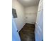 A laundry room with a shelf featuring wood-look flooring at 3689 Deer Springs Trl, Ellenwood, GA 30294