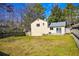 Back exterior of home, featuring a sliding glass door to the backyard and a well-maintained lawn at 6929 Hickory Log Rd, Austell, GA 30168