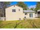 Back exterior of home, featuring a sliding glass door to the backyard and a well-maintained lawn at 6929 Hickory Log Rd, Austell, GA 30168