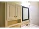 Bathroom featuring a wall cabinet, framed mirror, vanity and sink at 6929 Hickory Log Rd, Austell, GA 30168