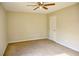 Spacious bedroom with neutral walls, carpet flooring, and a ceiling fan at 6929 Hickory Log Rd, Austell, GA 30168