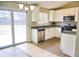 Updated kitchen with stainless steel appliances, white cabinets, and a sliding glass door to the yard at 6929 Hickory Log Rd, Austell, GA 30168