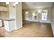 Living area with wood floors, natural light, and an open layout next to the kitchen at 6929 Hickory Log Rd, Austell, GA 30168