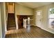 Inviting living room features hardwood floors, a stone fireplace, and a staircase leading to the second floor at 6929 Hickory Log Rd, Austell, GA 30168