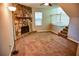 Cozy living room features a stone fireplace and access to the staircase leading to the second floor at 6929 Hickory Log Rd, Austell, GA 30168