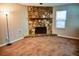 Living room showcasing a stone fireplace, neutral walls, and large carpeted area at 6929 Hickory Log Rd, Austell, GA 30168