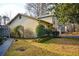 Charming home featuring well maintained lawn and landscaping, with a paved walkway to the side entrance at 6929 Hickory Log Rd, Austell, GA 30168
