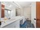 Bathroom featuring double sinks, skylights and blue tiled floor at 3032 Ross Rd, Snellville, GA 30039