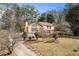 Aerial front exterior view of a two-story home with manicured front yard and mature trees at 3032 Ross Rd, Snellville, GA 30039