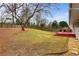 Large backyard featuring a spacious lawn and a red deck with outdoor seating at 3351 Creatwood Se Trl, Smyrna, GA 30080