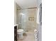 Tiled bathroom shower with shower caddy, recessed shelving and nearby toilet at 3351 Creatwood Se Trl, Smyrna, GA 30080