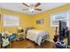 Sunlit bedroom with hardwood floors, a ceiling fan and two windows at 3351 Creatwood Se Trl, Smyrna, GA 30080