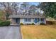 Charming single-story home with gray siding, blue accents, covered carport, and a well-maintained lawn at 3351 Creatwood Se Trl, Smyrna, GA 30080