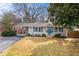 Charming single story home with blue door, blue shutters, carport and manicured front lawn at 3351 Creatwood Se Trl, Smyrna, GA 30080