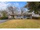 Charming single story home with blue door, blue shutters, carport and manicured front lawn at 3351 Creatwood Se Trl, Smyrna, GA 30080