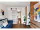 Cozy living room with sliding barn door, wood accent wall and view into front entry at 3351 Creatwood Se Trl, Smyrna, GA 30080