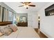 Light-filled bedroom with a ceiling fan, decorative lamps, and dresser with mirror at 3351 Creatwood Se Trl, Smyrna, GA 30080