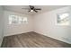 Bright bedroom with wood-look flooring, inviting natural light and a ceiling fan at 4324 Rue Saint Michel, Stone Mountain, GA 30083