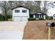 Charming two-story home with white siding, black trim, and a spacious two-car garage at 4324 Rue Saint Michel, Stone Mountain, GA 30083