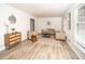 Bright living room with neutral-toned furniture, new floors, and natural light from large windows at 4324 Rue Saint Michel, Stone Mountain, GA 30083