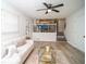 Bright living room open to kitchen, featuring wood floors, ceiling fan, and easy access to the kitchen at 4324 Rue Saint Michel, Stone Mountain, GA 30083