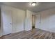 Bedroom featuring hardwood-style flooring and two closets with white doors at 5990 Mallory Rd, South Fulton, GA 30349