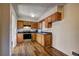 Functional kitchen with wood cabinets, stainless steel appliances, and dark countertops with wood flooring at 5990 Mallory Rd, South Fulton, GA 30349