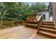 A wooden deck and seating area offering an outdoor living space amid mature trees at 3996 Spalding Ln, Atlanta, GA 30350