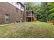 Spacious backyard featuring lush greenery, a screened-in porch, and a trampoline at 3996 Spalding Ln, Atlanta, GA 30350