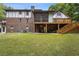 Expansive backyard with lush greenery, a screened-in porch, and an outdoor patio at 3996 Spalding Ln, Atlanta, GA 30350