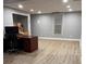 A bright unfinished basement with vinyl floors offers ample storage and workspace near a window at 3996 Spalding Ln, Atlanta, GA 30350