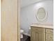 A neutral toned powder room features a granite vanity, elegant fixtures, and a decorative round mirror at 3996 Spalding Ln, Atlanta, GA 30350