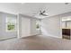 Spacious bedroom with a ceiling fan, neutral carpet, and large windows for natural light at 3996 Spalding Ln, Atlanta, GA 30350