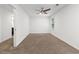 Bright bedroom with a ceiling fan, neutral carpet, and a doorway leading to an en-suite bathroom at 3996 Spalding Ln, Atlanta, GA 30350