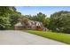 Charming brick home boasts a large front yard, long driveway, and basketball hoop at 3996 Spalding Ln, Atlanta, GA 30350
